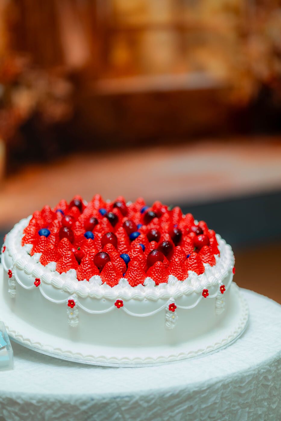 Red and white celebration cake on an event table