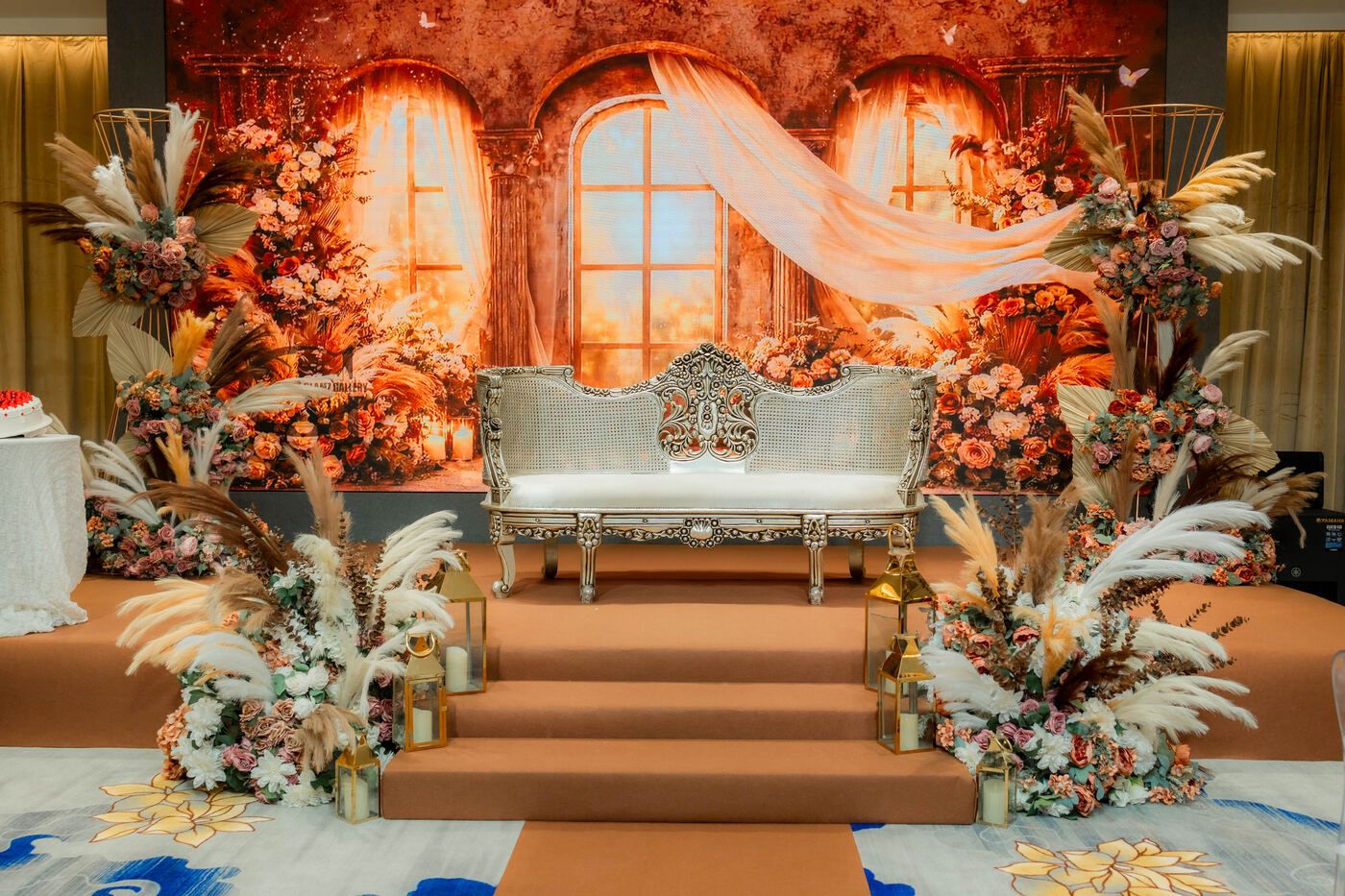 Full event room setup with stage and aisle at De Villa