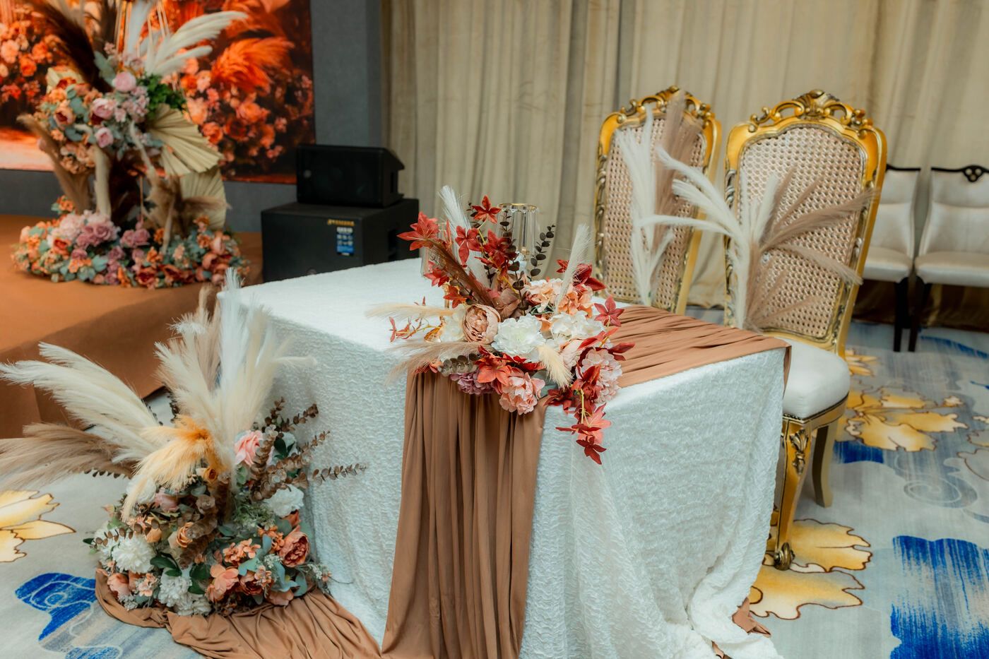 Stage and signing table setup with florals