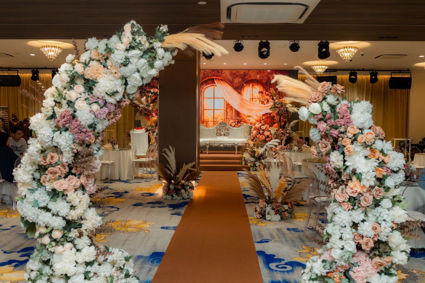 Floral aisle entrance leading to the stage
