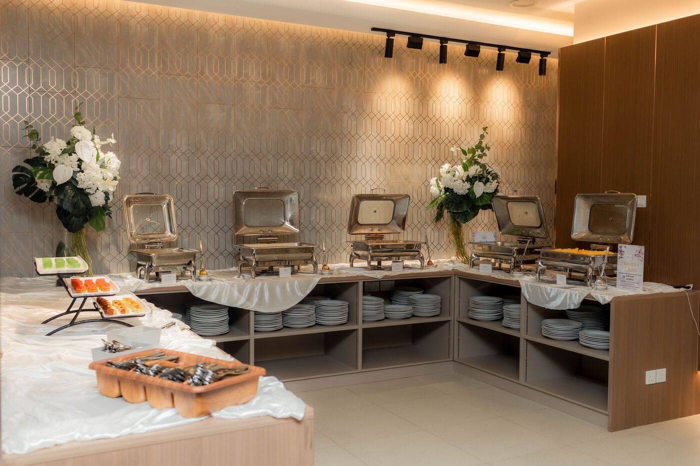 Buffet serving line with trays and warmers