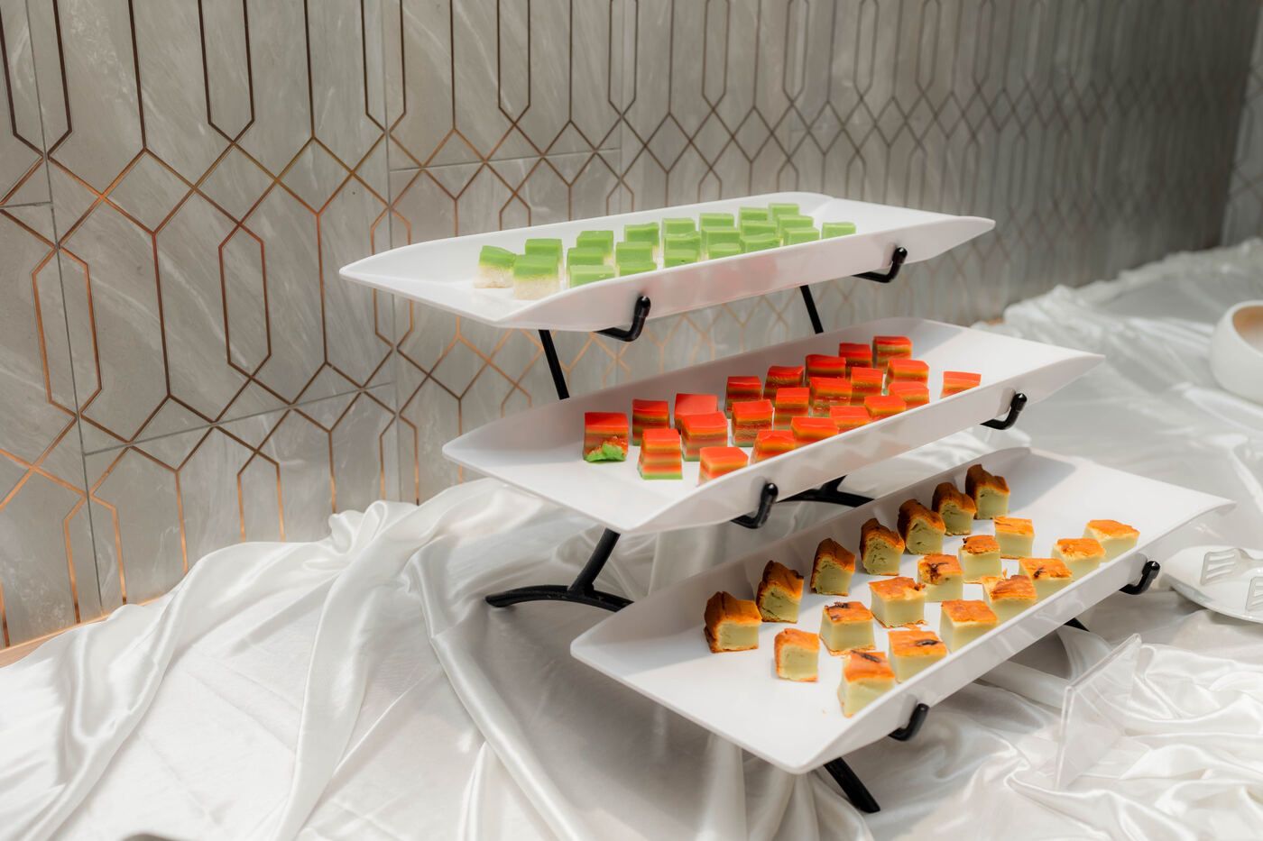 Bite-sized desserts arranged on a white serving tray