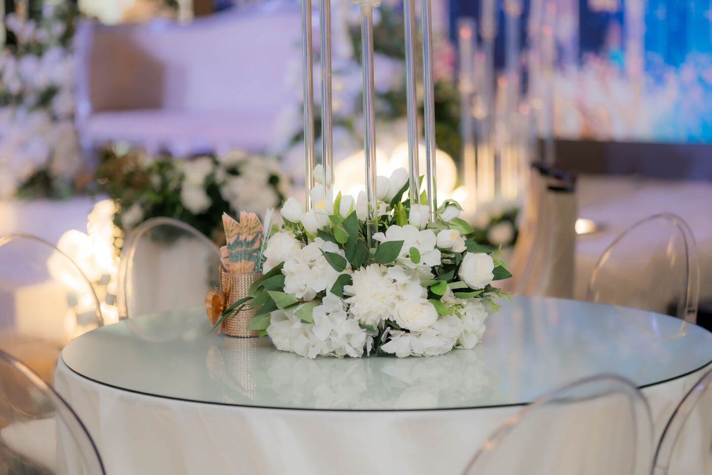 White floral centrepiece on a guest table