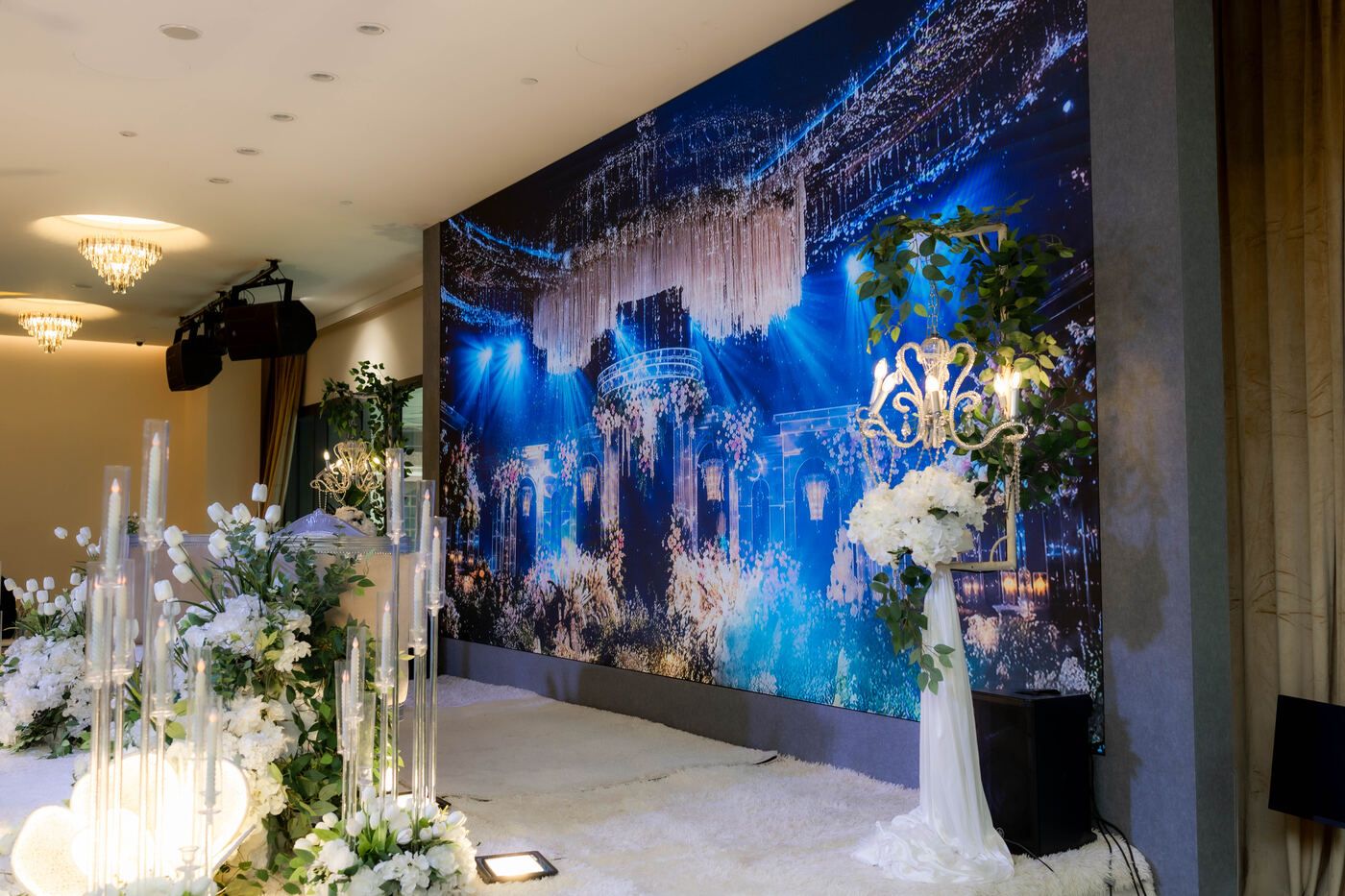 Wedding stage seating with white floral arrangements
