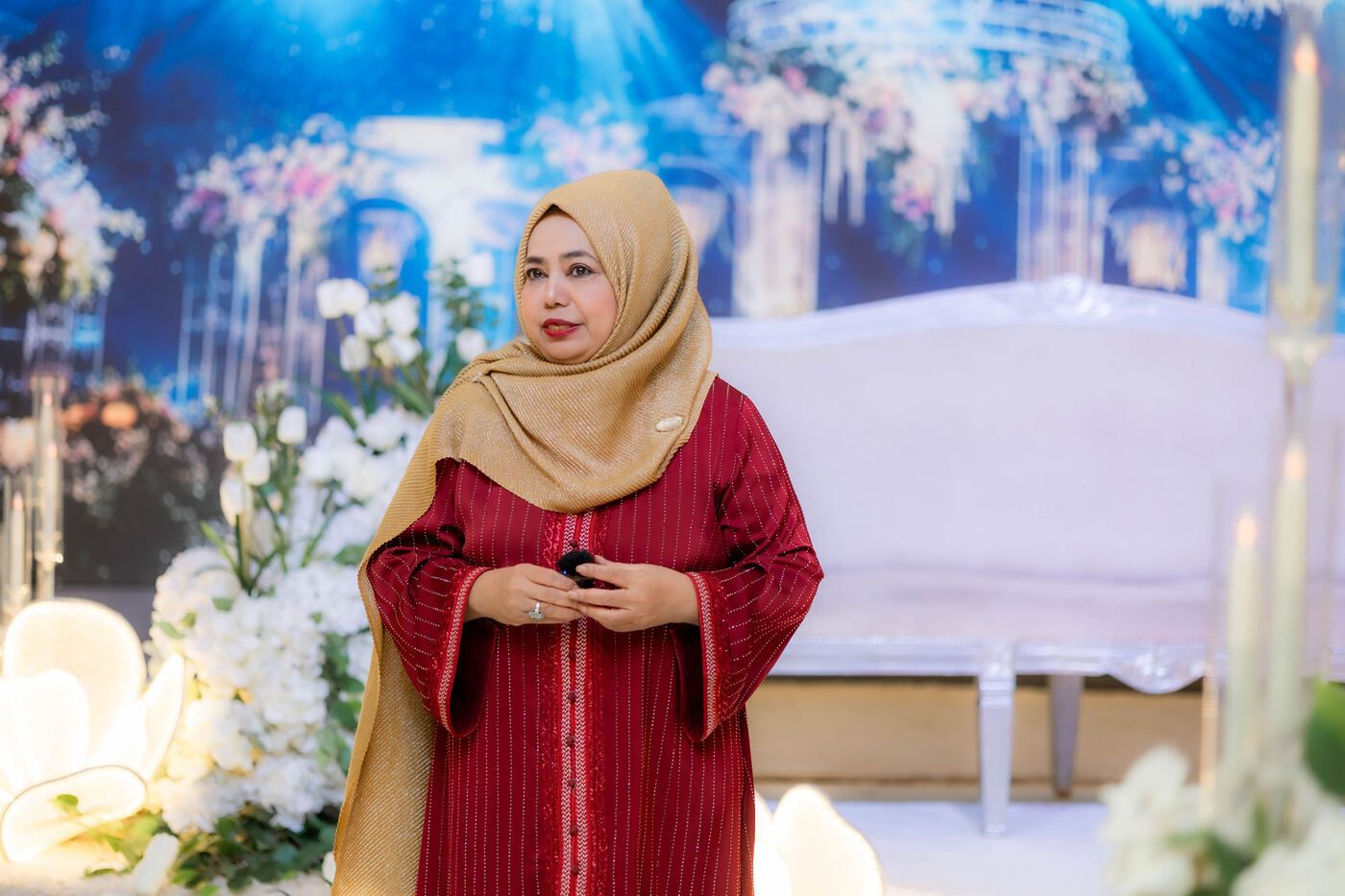 A De Villa host standing in the decorated ballroom