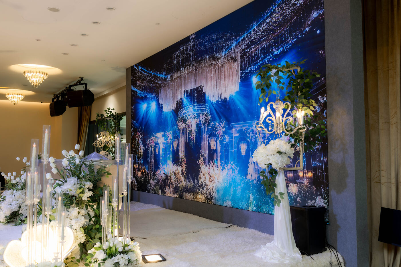 Wedding stage seating with white floral arrangements